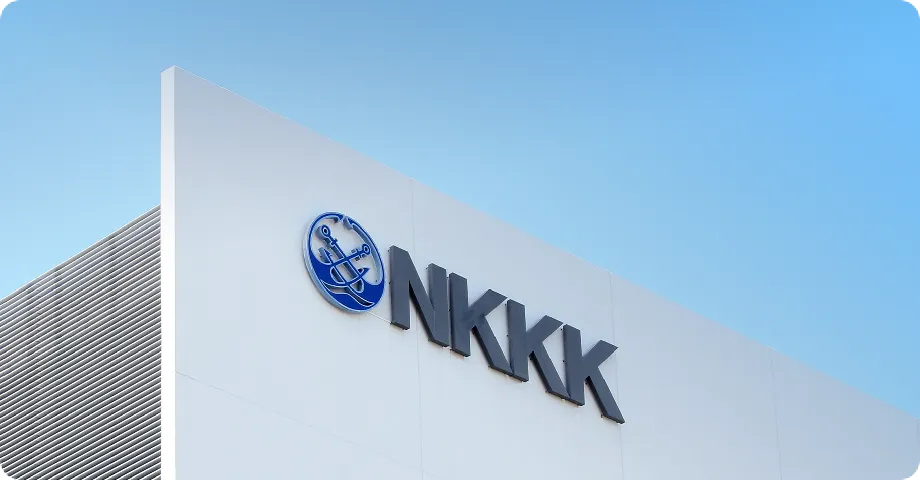 The exterior wall of a building with the NKKK logo