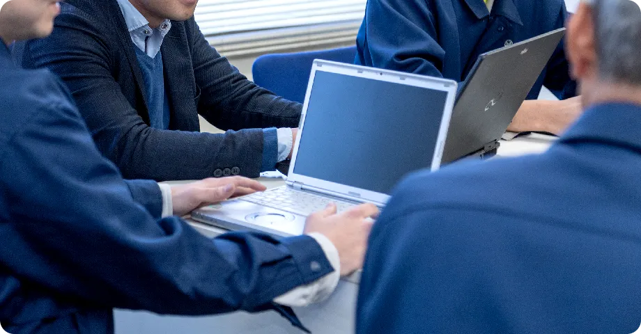 People using laptops in a meeting
