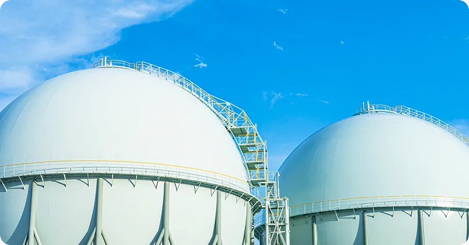 石油タンクと水辺の風景